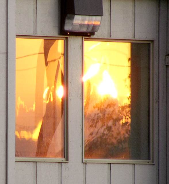 Fiery sunset reflects in window