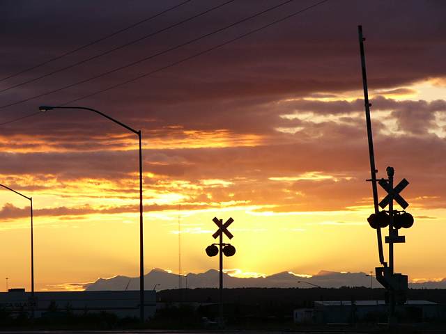 The sun sets behind the Alaska Range
