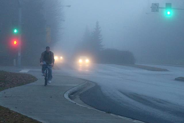 Waiting for the bus on a foggy morning