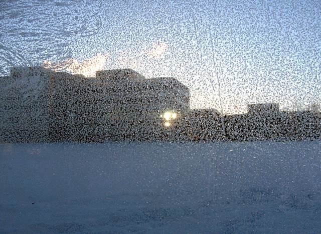 The Federal Building as seen through the frosty glass of the bus shelter.