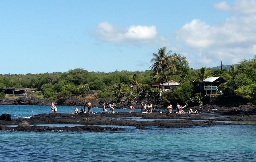 People out on the rocks near Pu`uhonua o Honaunau