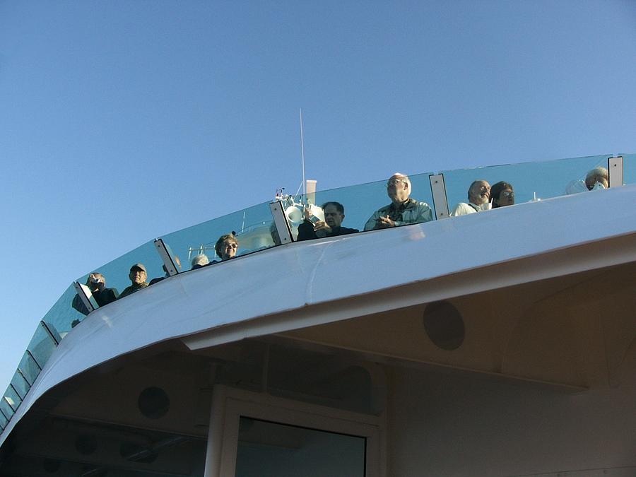 Passengers watching our departure from the deck above me.