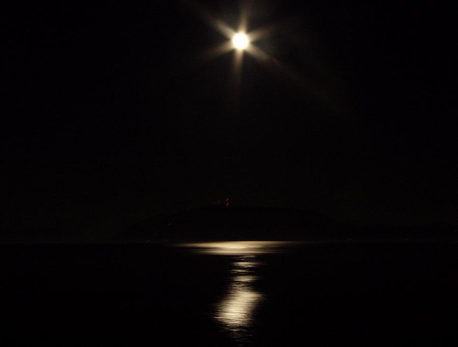 The moon reflects off the waters of upper Puget Sound