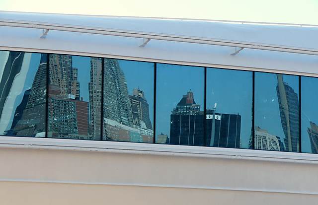 Midtown Manhattan reflected in the windows of Skywalker's Nightclub at the rear of the Golden Princess.