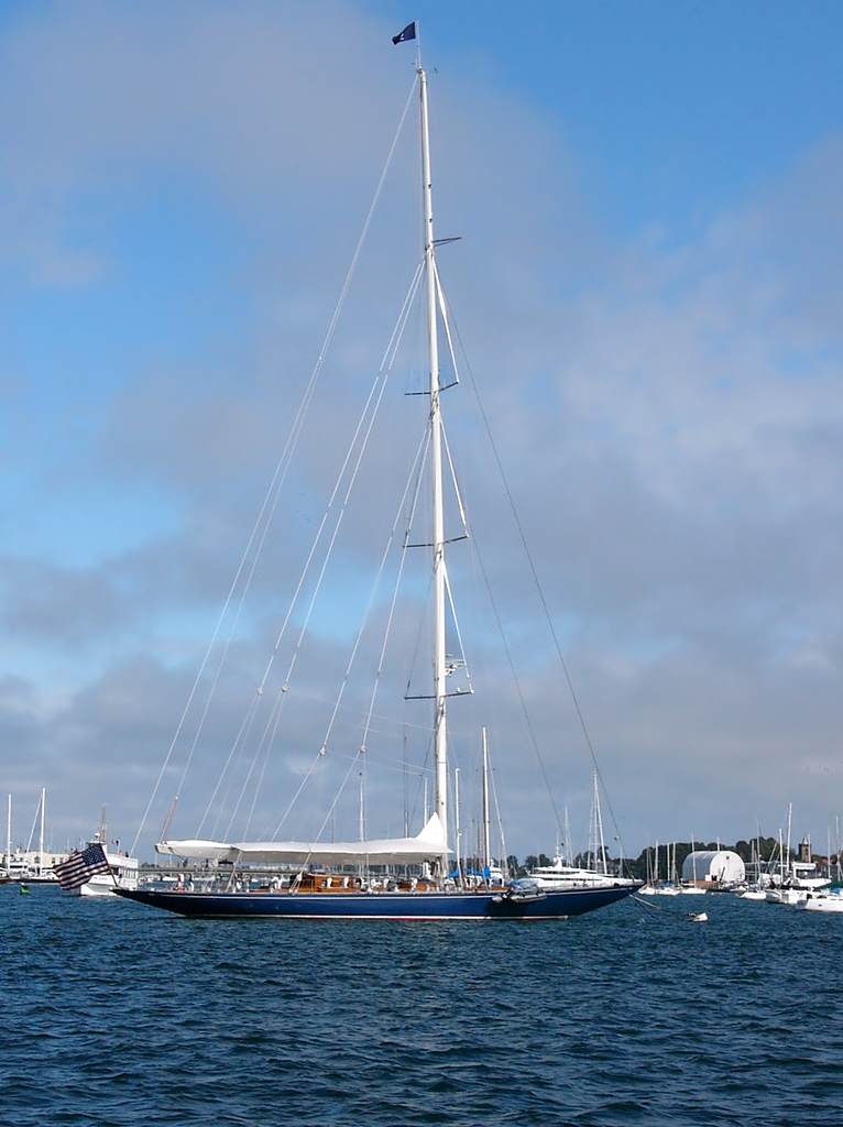 A yacht moored in Newport Harbor, while the last of the fog burns off above.